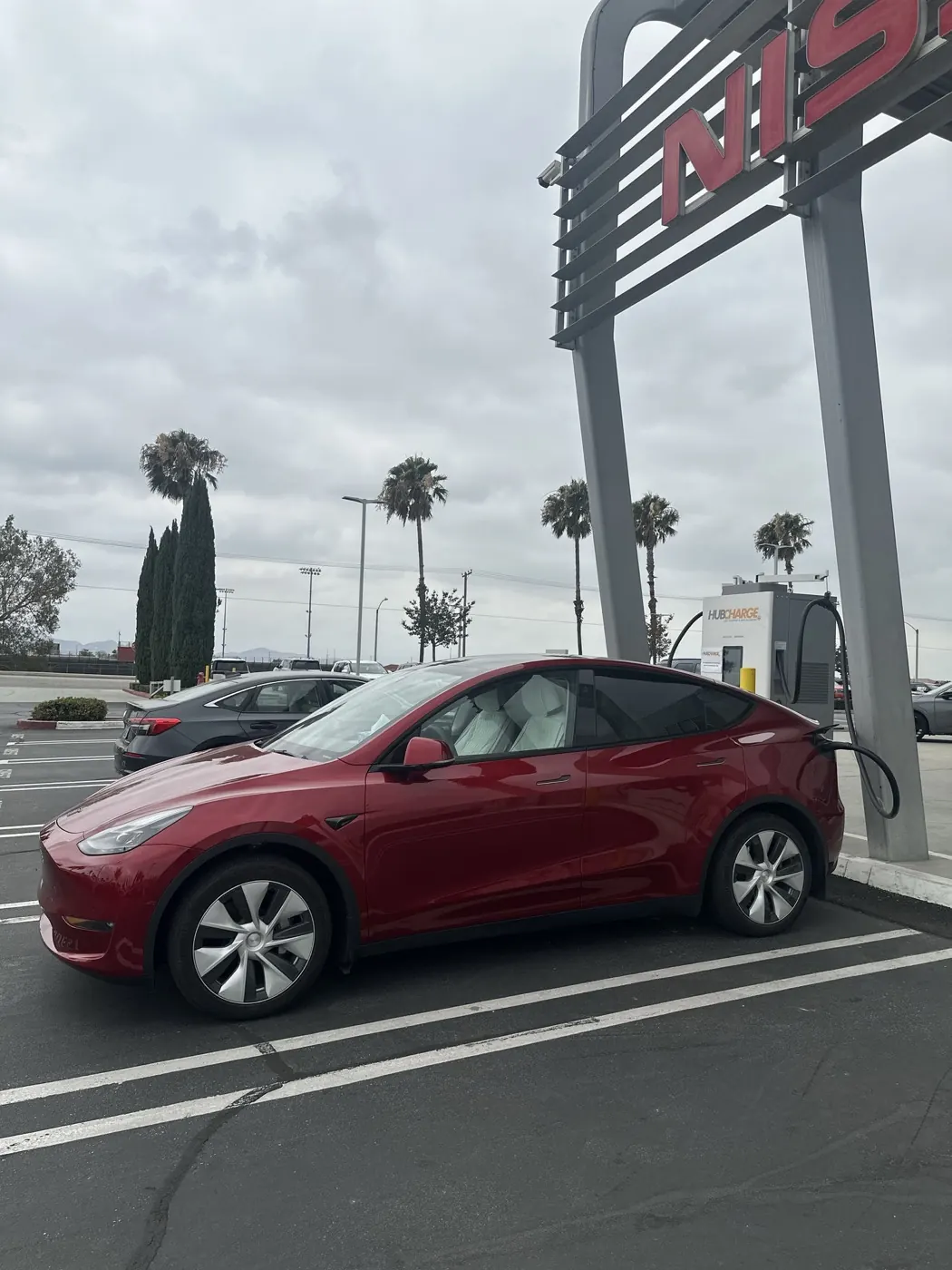 A Tesla Model Y connected to the HubCharge charger at Fontana Nissan